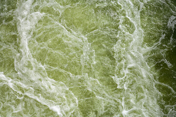 Churning water. Turbulence on the water surface. Troubled water as a background.
