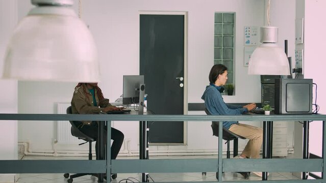 Senior developers coding on laptop in software agency office, parsing code and developing it language. Team innovating machine learning algorithms and using firewall security server.
