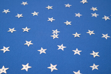 Silver stars on a blue background. Festive background for your ideas