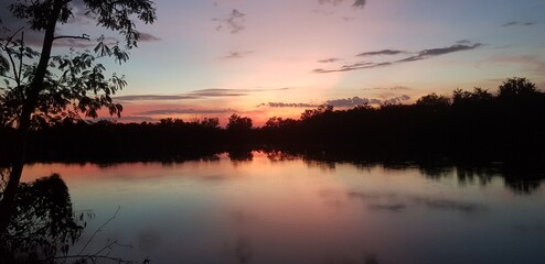 Fototapeta na wymiar Everning silhouette sunset on tropical forest river