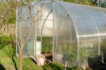 greenhouse on a private plot on a sunny day
