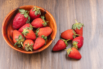 Fresh and Juicy beautiful organic strawberries on wooden background. Top view point.