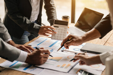 Businessman and team analyzing financial statement Finance task. with smart phone and laptop and ...