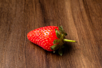 Fresh and Juicy beautiful organic strawberries on wooden background. Top view point.