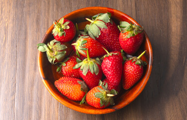 Fresh and Juicy beautiful organic strawberries on wooden background. Top view point.