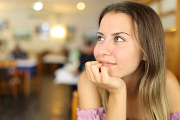 Happy teen looking at side in a restaurant