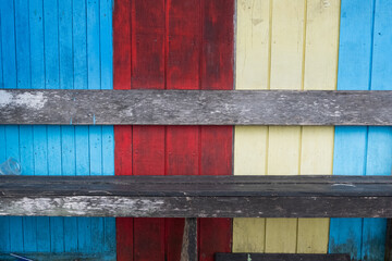 old wooden chair against colorful wooden wall background, for typography, copy space