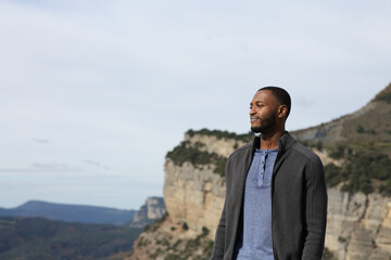 Black man contemplating views in the mountain