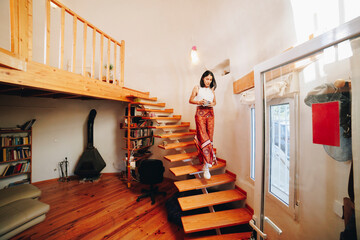Mature woman moving down stairs at home