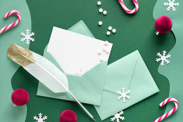 Writing Christmas greetings - quill and greeting cards in paper envelopes. Xmas background with...