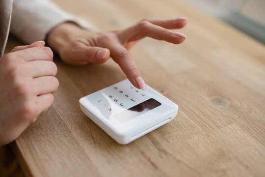 Hand of businesswoman using credit card reader on table
