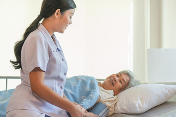 Personal service nurse take care elder disable patient on the bed at home