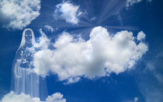 Saint Therese of Child Jesus statue on white clouds with light ray at heaven. religion, catholicism concept..