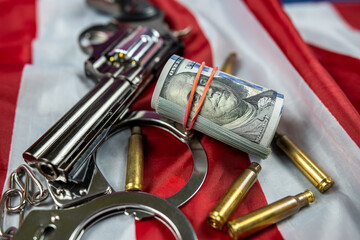 Cash and weapons with ammunition and handcuffs on an American flag were seized.