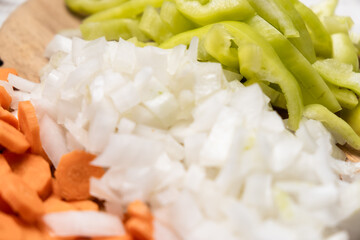 Chopped fresh peppers, onions, carrots. Vegetarianism concept. Mix of vegetables.