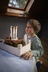 A child blows out candles, Christmas Advent