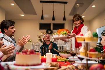 Multi-ethnic big family celebrating Christmas party together in house. 