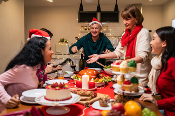 Multi-ethnic big family celebrating Christmas party together in house. 