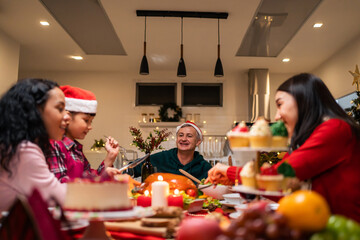 Multi-ethnic big family celebrating Christmas party together in house. 