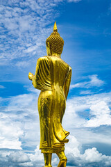 Close-up golden buddha statue with sky