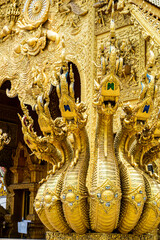 Close-up golden statue in temple