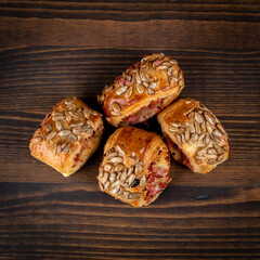 Meat patties with seeds. Wood texture background