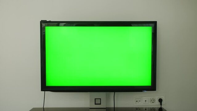 TV mockup screen. LED smart TV green screen with a in the living room.