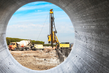 Hydraulic drilling machine at the construction site makes piles. Pile field. Modern drilling rig.