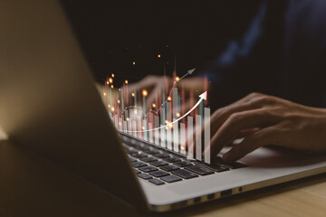 Businessman using a laptop to plan stock market analysis strategy with graphs chart