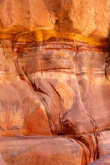 The Siq, narrow red canyon wall texture background in Petra, Jordan, UNESCO World Heritage Site