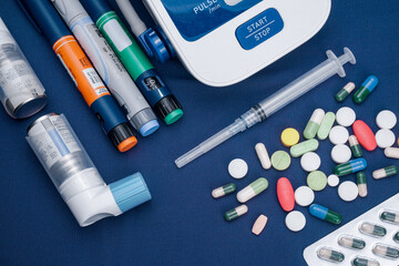 Picture of medical drugs pills, sryinge, insulin pen, automatic blood presure monitor device and...
