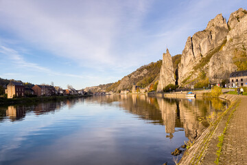 Rocher Bayard with its reflection on the Meuse river in Dinant, Belgium - obrazy, fototapety, plakaty