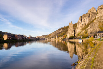 Rocher Bayard with its reflection on the Meuse river in Dinant, Belgium
