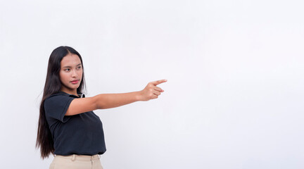 A stoic and pensive asian woman wearing a black polo shirt points to the left with her finger....