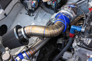 Stainless air intake pipe to turbo charger in car.