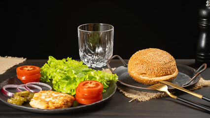 Bun and burger ingredients on a dark table