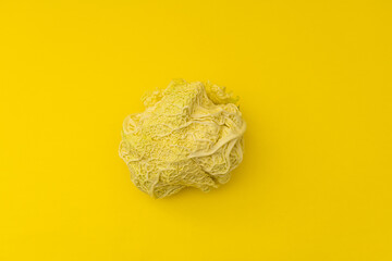 White cabbage lies on a yellow background