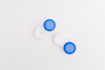 Subject photography of contact lenses on a blue background, with lens fluid