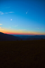 Countryside silhouettes with Moon, stars, planets and shooting stars.