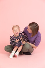 studio portrait of mother with her daughter