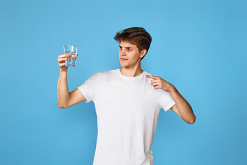 Young handsome man with drinking glass of water