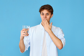 Young handsome man with drinking glass of water