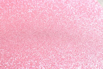 Beautiful pink shiny glitter as background, top view