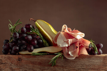 Prosciutto with rosemary, pear, and grapes.