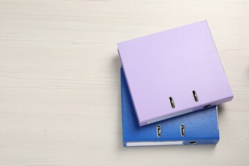 Office folders on white wooden table, flat lay. Space for text