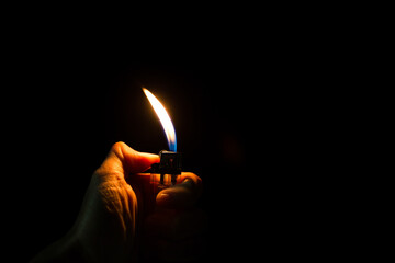 abstract Motion Hand with lighter igniting sparks on dark background