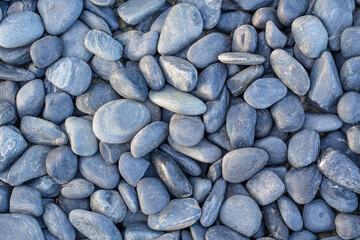 small smooth waterworn black pebbles or stones for use decor and garden landscaping. tone garden...