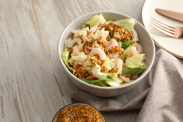 Delicious salad with Chinese cabbage, shrimps and mustard seed dressing on white wooden table, space for text