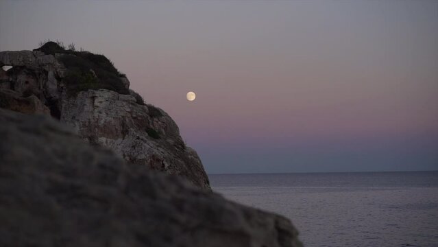 Sunset in Mallorca with the moon in the background