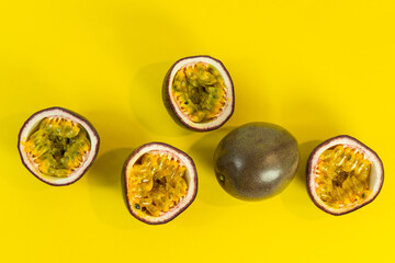 Sliced passion fruit. Fresh passion fruit on a yellow background. Selective focus.